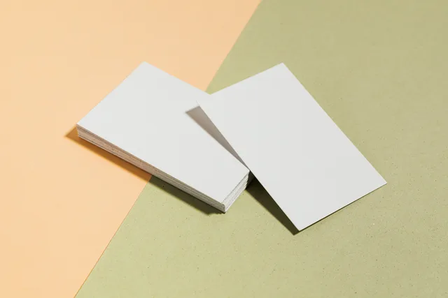 Stack of blank white business cards on pastel surface offering copy space for design. How to review and compare sponsorship rates for UK brand deals