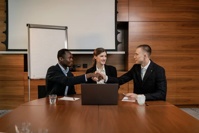 Diverse business team having a successful meeting and agreement, shaking hands across the table. Which sponsorship rates strategy mistakes cost brands the most?